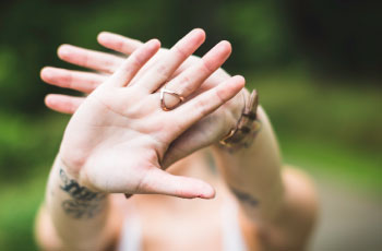 Girl holding her hands in front of her face